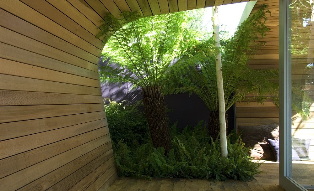 Curved cedar walls of a garden room