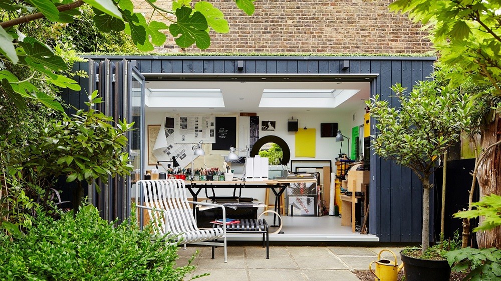 Bespoke garden office with dark cladding and bifolding doors